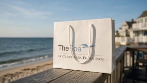 The Spa at Chatham Bars Inn Custom Euro Tote sitting on the railing looking out at the ocean.